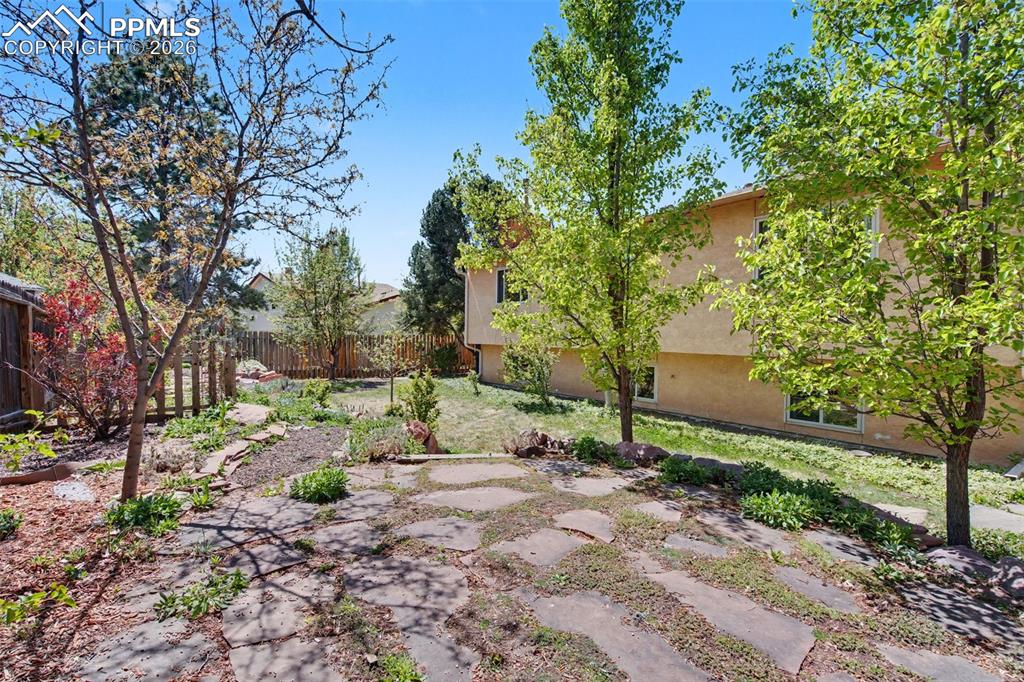 5301 Pinon Valley Road Colorado Springs, CO 80919 - Photo 23 of 27 a backyard of a house with lots of green space