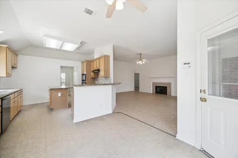 a view of a kitchen with furniture and a fireplace