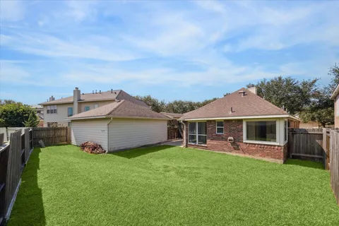 a front view of a house with a yard table and chairs