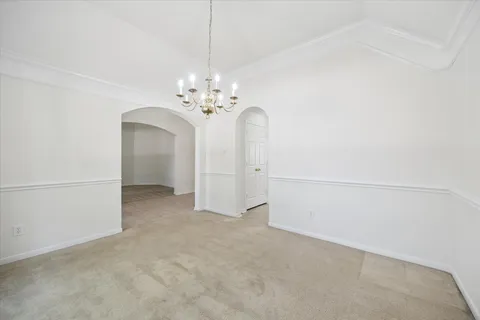 a view of a chandelier in big room and chandelier