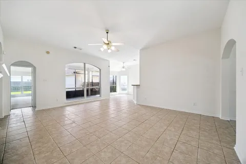 wooden floor with chandelier and glass door
