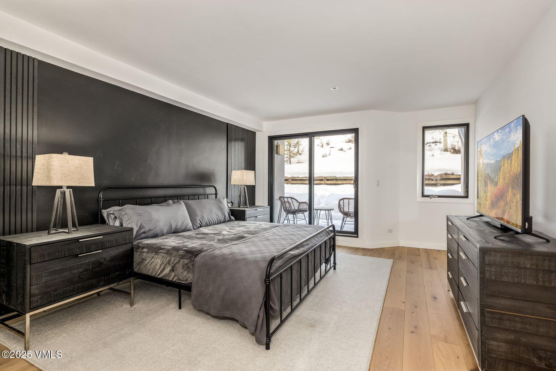 311 Offerson Road, Unit 232 Beaver Creek, CO 81620 - Photo 12 of 42 a bedroom with a bed and a flat tv screen on dresser