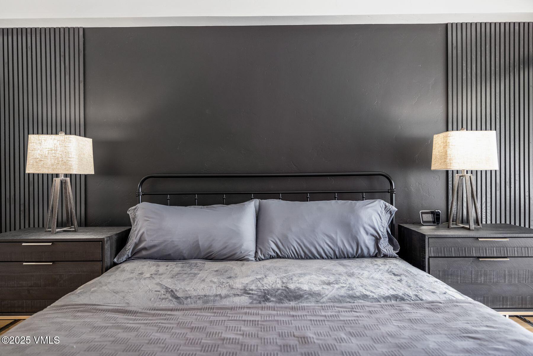 311 Offerson Road, Unit 232 Beaver Creek, CO 81620 - Photo 13 of 42 a large bed sitting in a bedroom next to a lamp