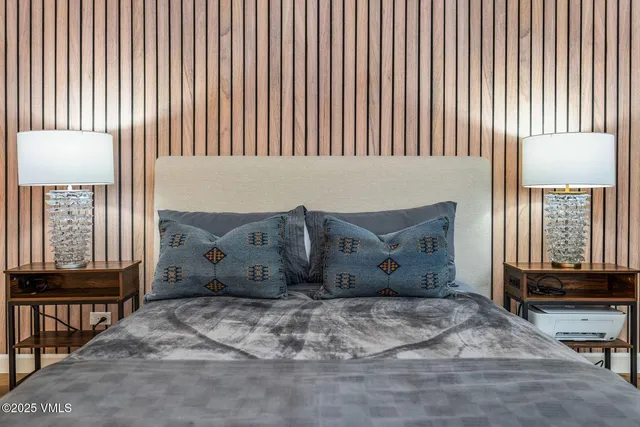 a view of a bedroom with furniture and window