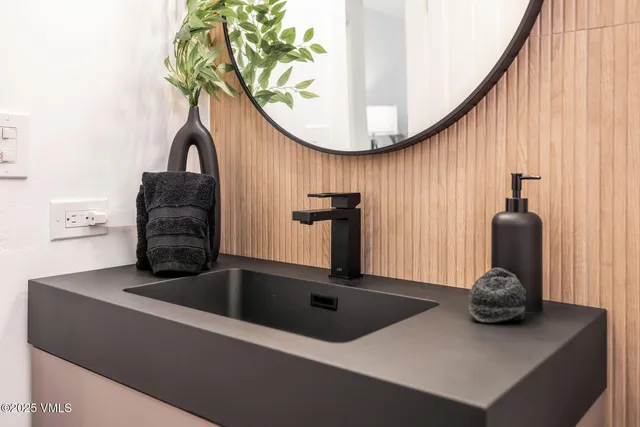 a view of a livingroom with furniture and mirror