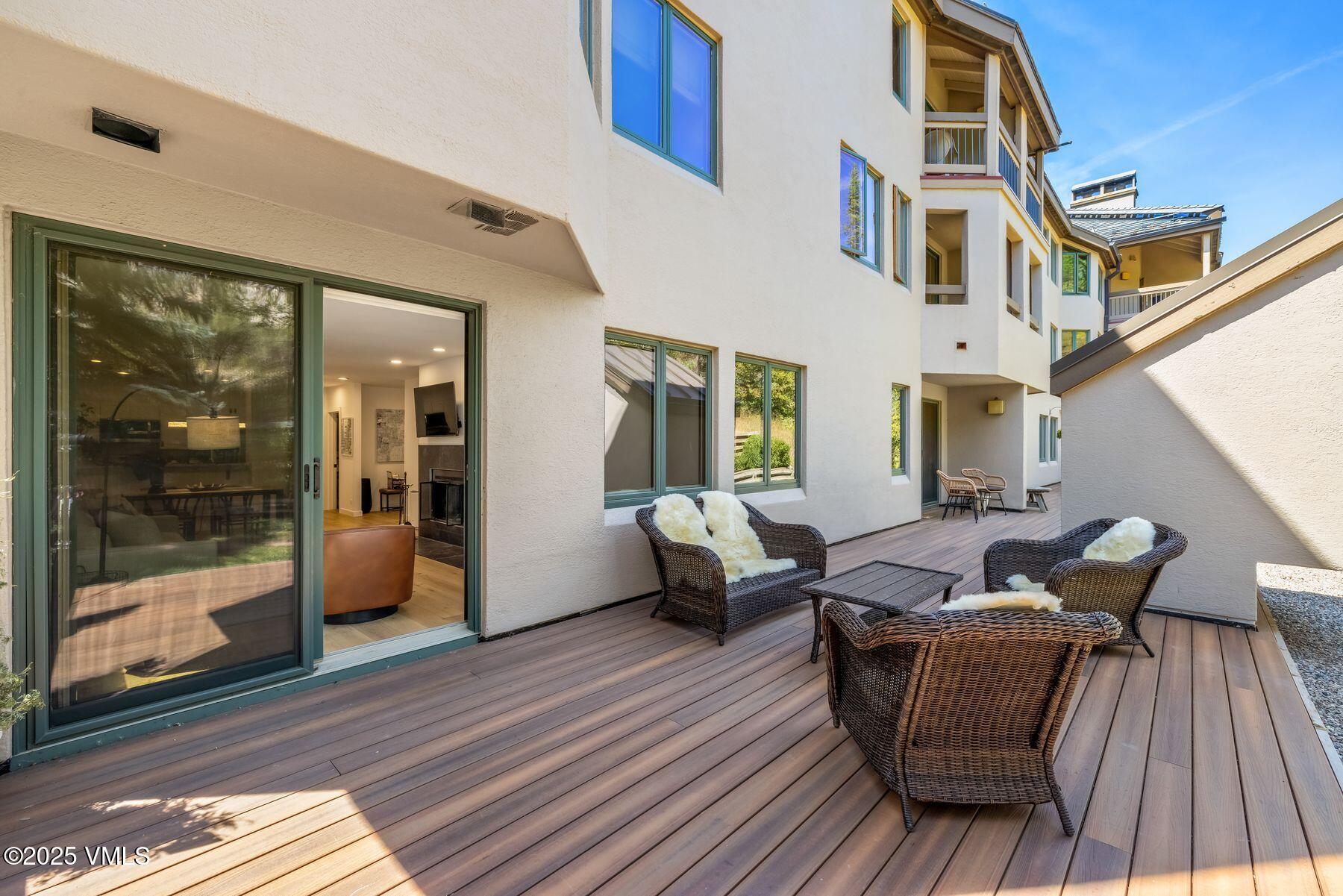 311 Offerson Road, Unit 232 Beaver Creek, CO 81620 - Photo 26 of 42 a balcony with wooden floor and glass door