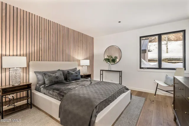 a living room with a bed furniture and a window