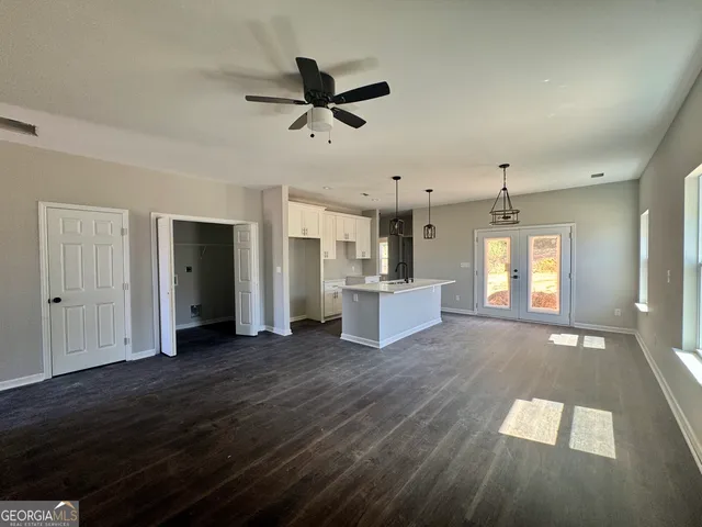 a view of a kitchen with wooden floor and a ceiling fan