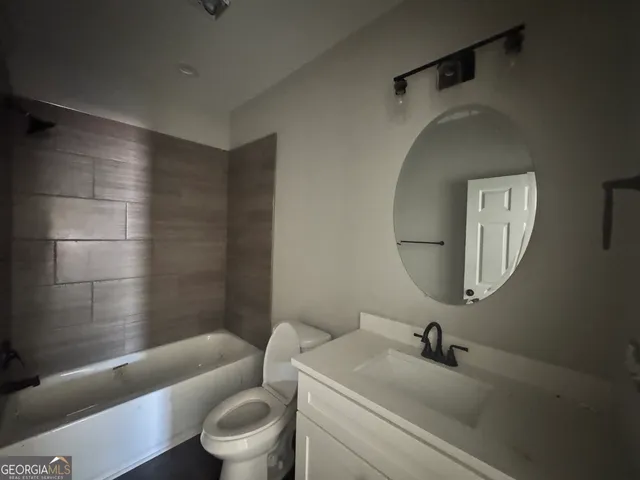a bathroom with a toilet a sink and bathtub