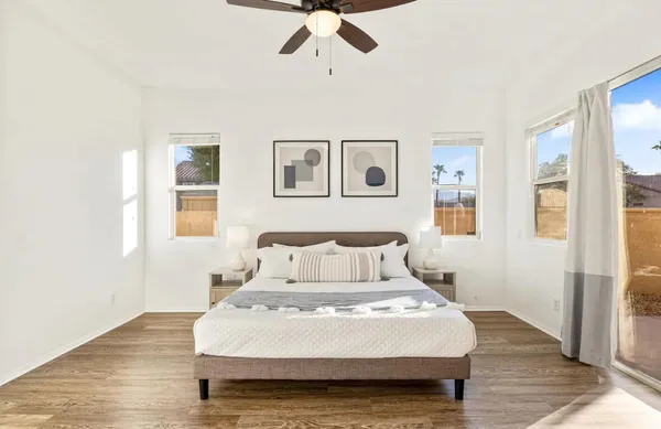a bedroom with a bed and wooden floor