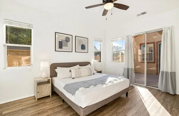 a bedroom with a large bed and a chandelier