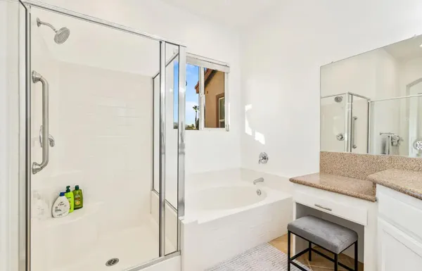 a bathroom with a bathtub shower and a sink