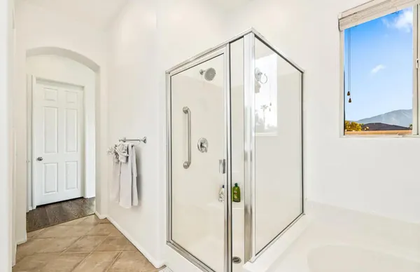 a bathroom with a shower and a mirror