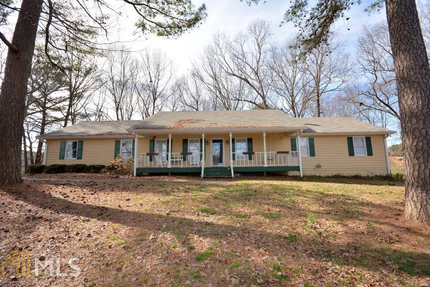 6645 Concord Road Cumming, GA 30028 - Photo 1 of 1 a front view of a house with a garden