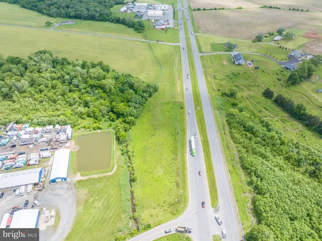 a view of a big yard with a house in the background
