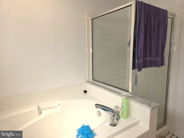a bathroom with a tub and a sink