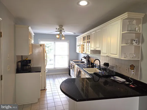 a kitchen with stainless steel appliances a stove a sink and a microwave