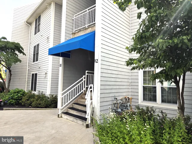 a view of a house with a yard and stairs