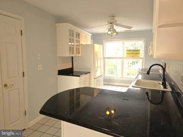 a view of a kitchen with a sink and a window
