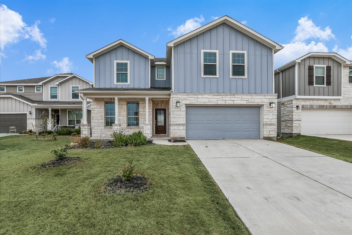 a front view of a house with a yard and garage