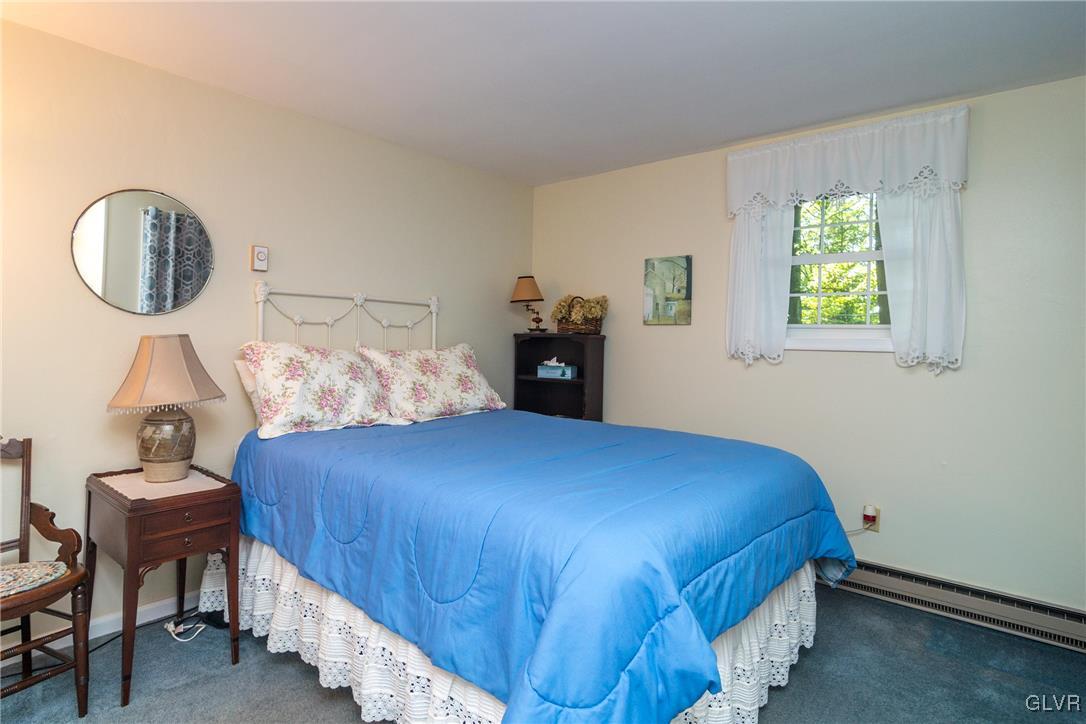 4127 Lower Saucon Road Hellertown, PA 18055 - Photo 17 of 28 a bedroom with a bed a mirror and a window
