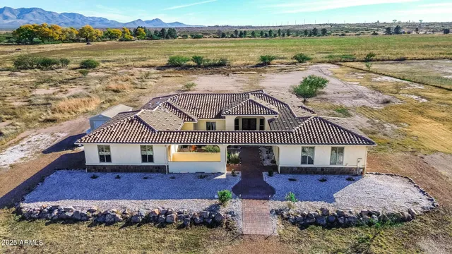 a view of a house with garden space and lake view