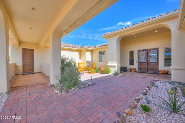 a view of a house with backyard porch and sitting area
