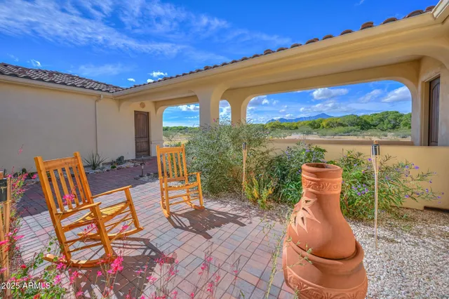 a view of two chairs in the patio