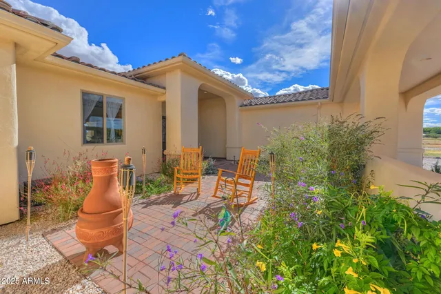 a view of a patio with table and chairs and potted plants