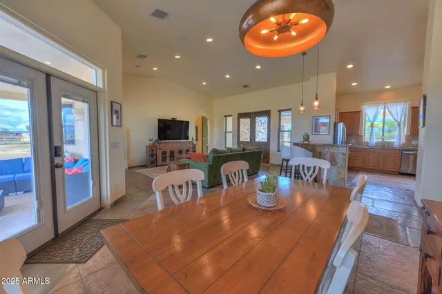 a dining room with furniture and a wooden floor