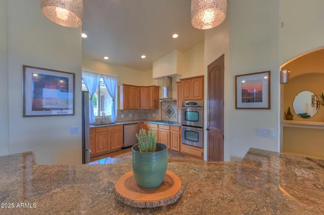 a kitchen with a refrigerator and a view of living room