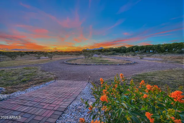 a view of a house with a yard and table