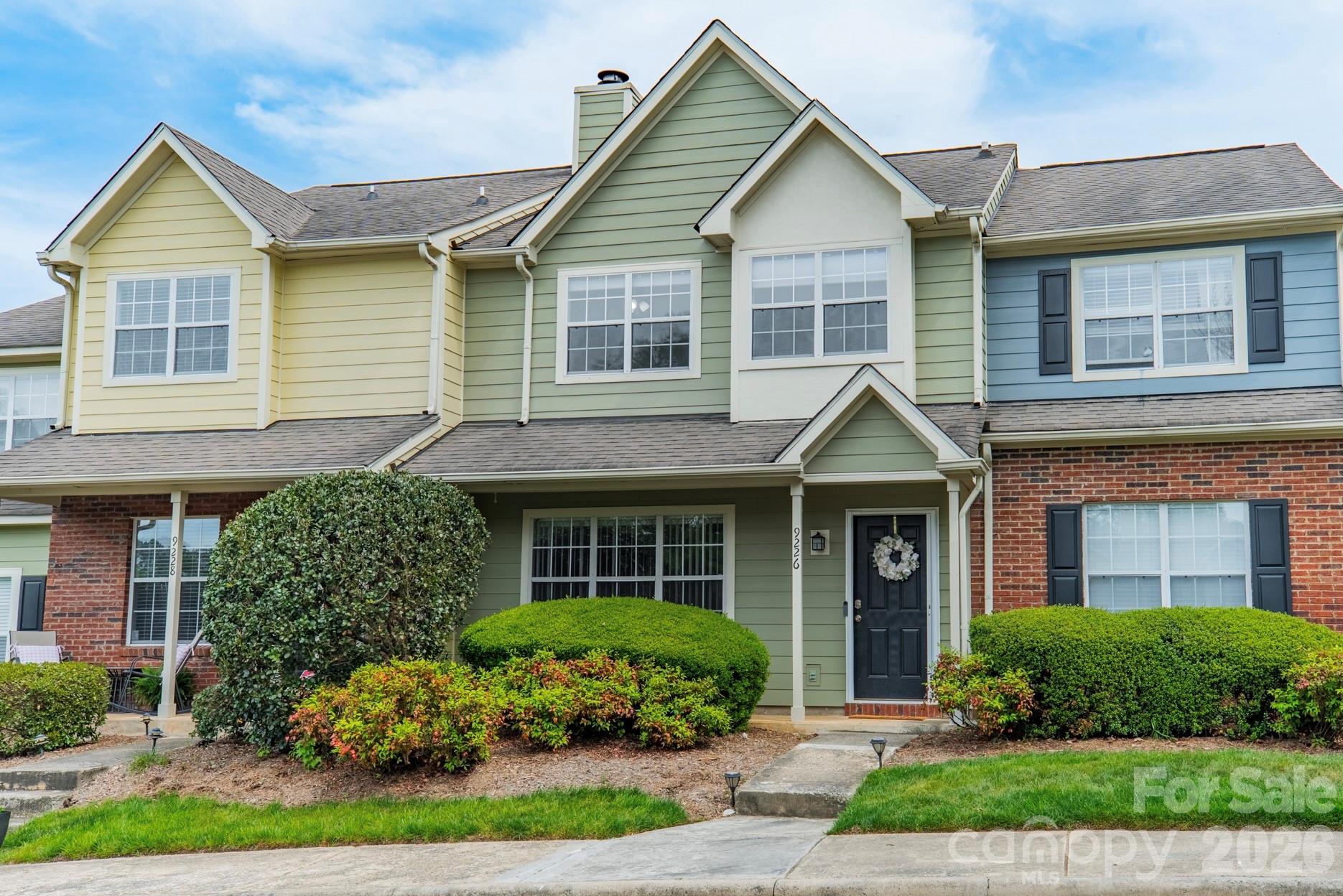 9226 Four Mile Creek Road Charlotte, NC 28277 - Photo 1 of 39 a front view of a house with a yard and potted plants