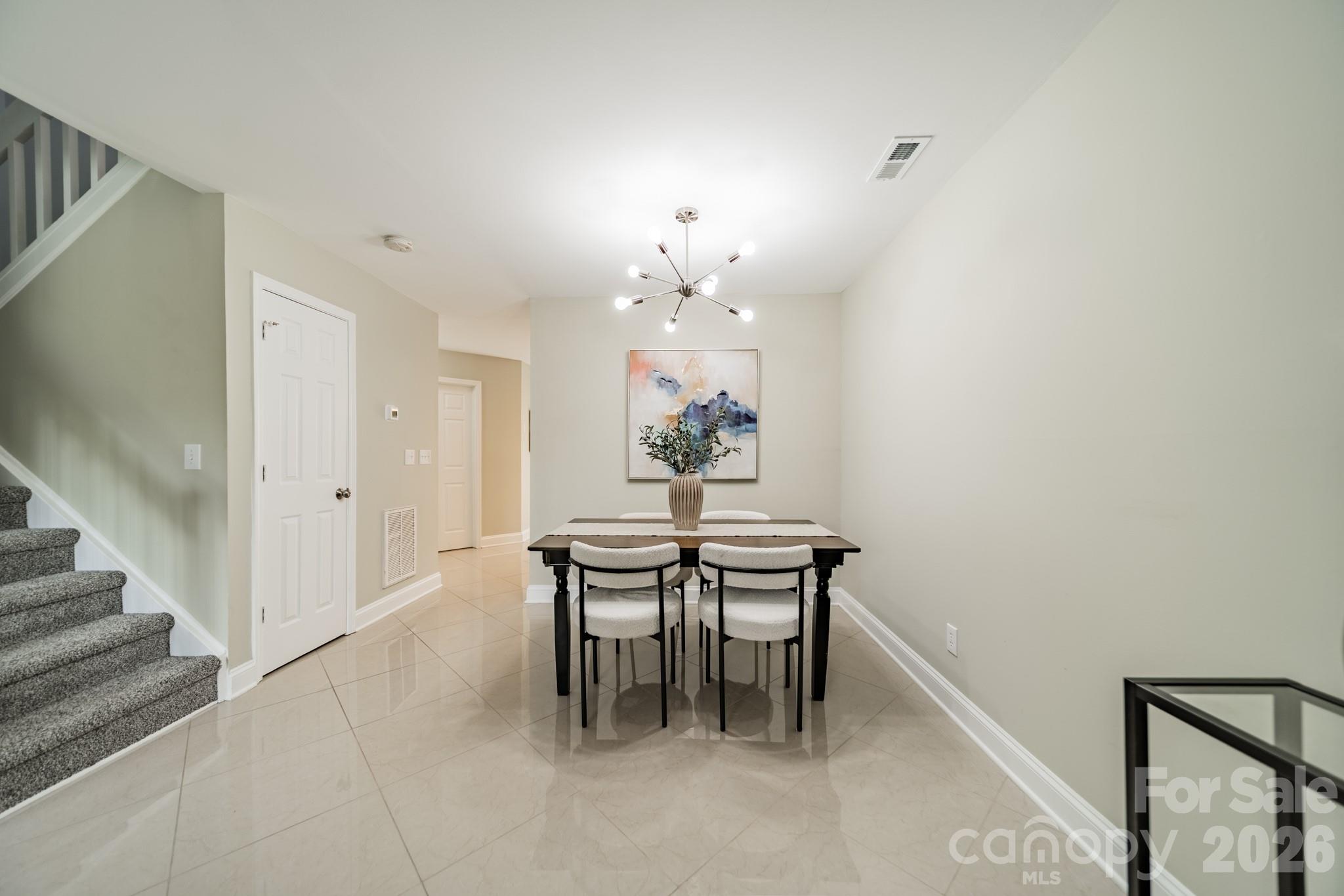 9226 Four Mile Creek Road Charlotte, NC 28277 - Photo 14 of 39 a dining room with furniture and chandelier