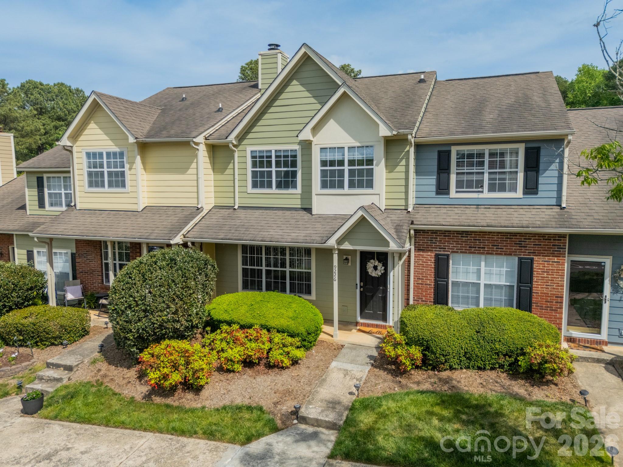 9226 Four Mile Creek Road Charlotte, NC 28277 - Photo 2 of 39 a front view of a house with a garden and plants