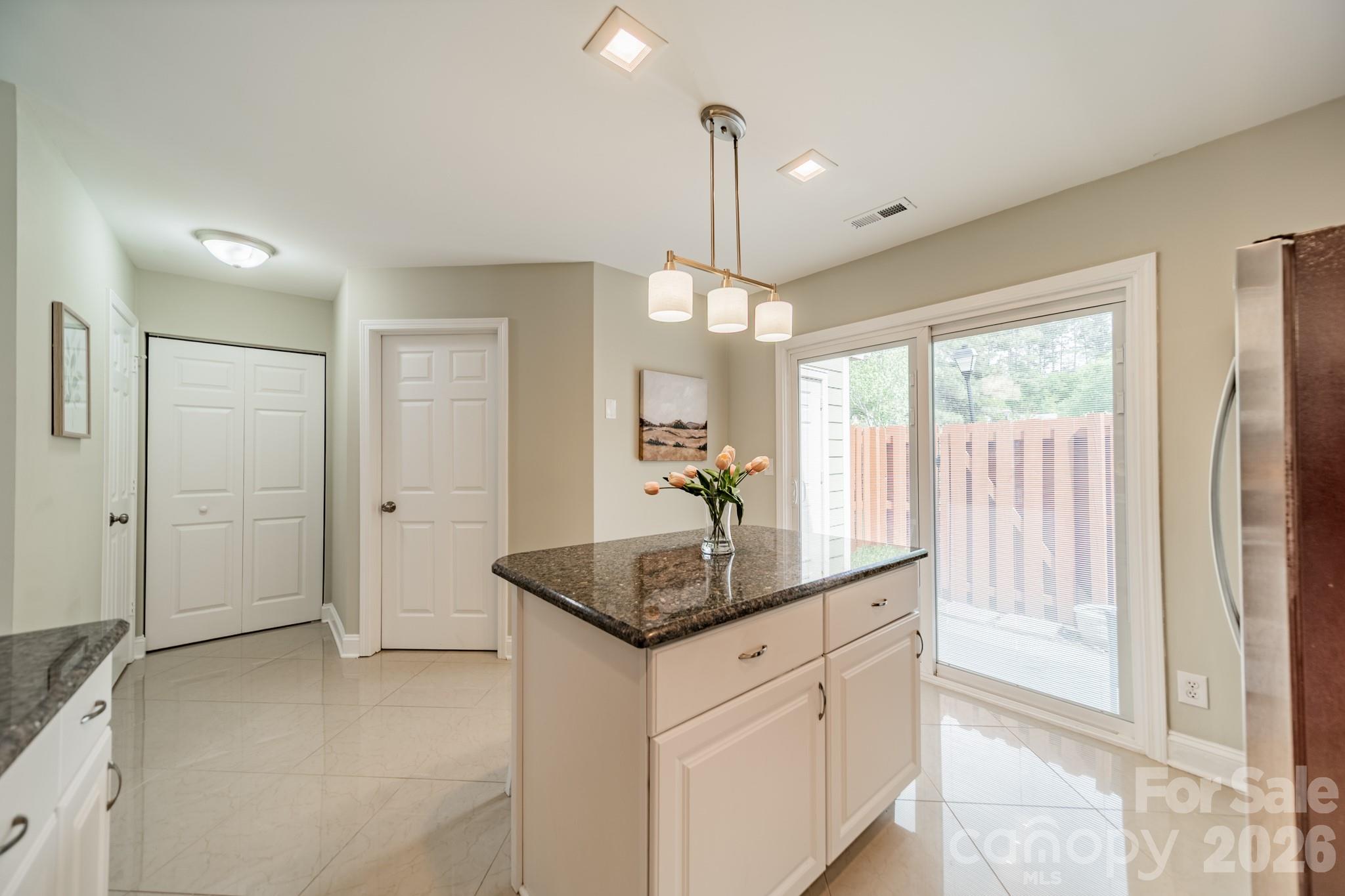 9226 Four Mile Creek Road Charlotte, NC 28277 - Photo 23 of 39 a kitchen with granite countertop a sink and a refrigerator