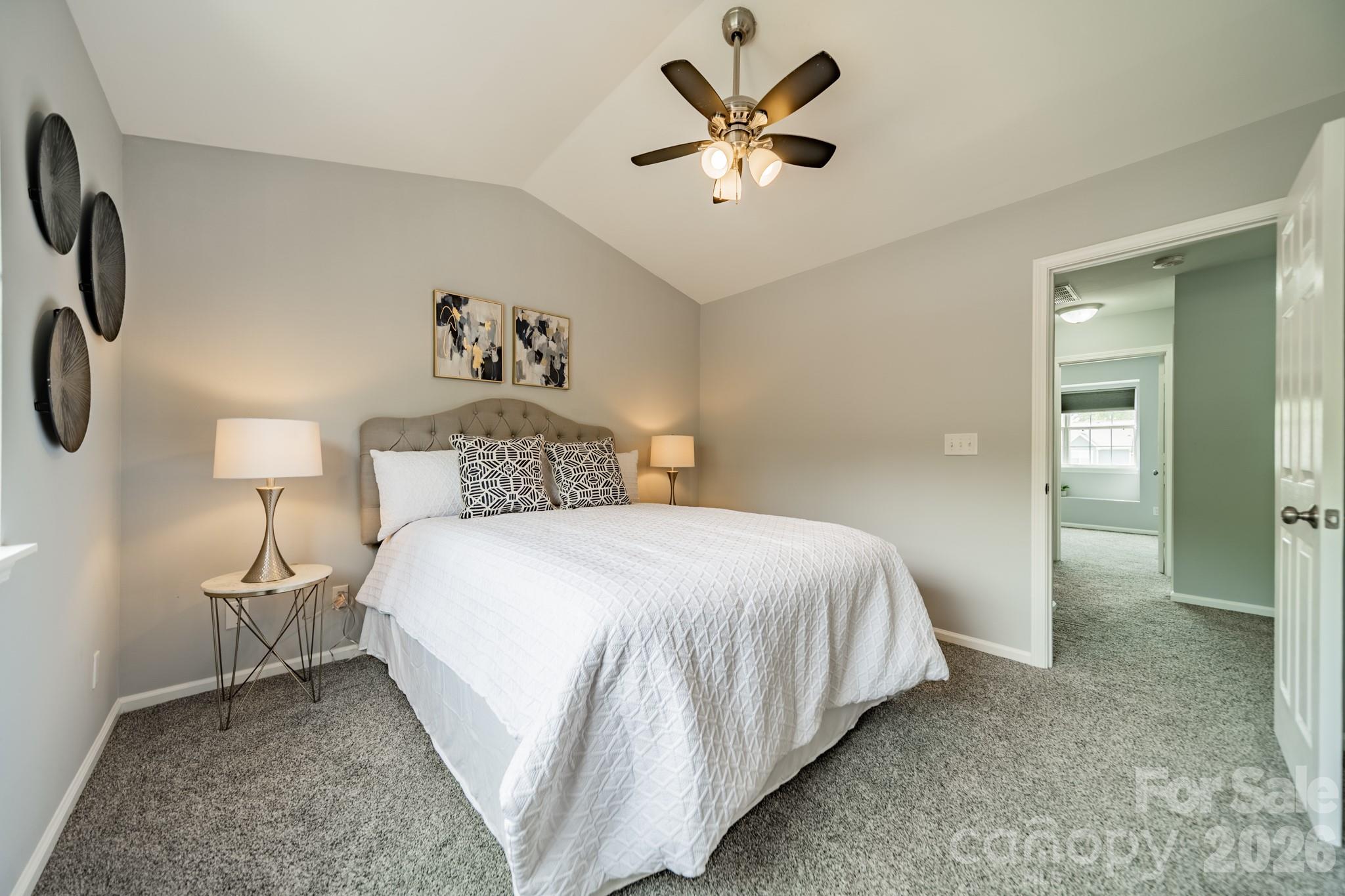 9226 Four Mile Creek Road Charlotte, NC 28277 - Photo 27 of 39 a bedroom with a bed and a chandelier