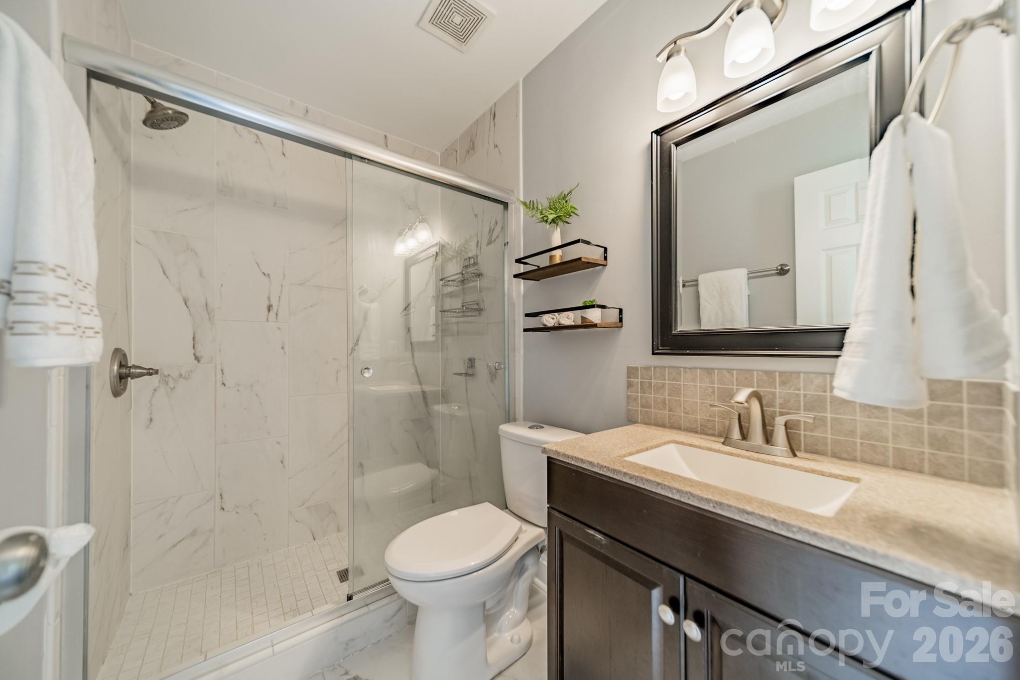 9226 Four Mile Creek Road Charlotte, NC 28277 - Photo 28 of 39 a bathroom with a sink a toilet and shower