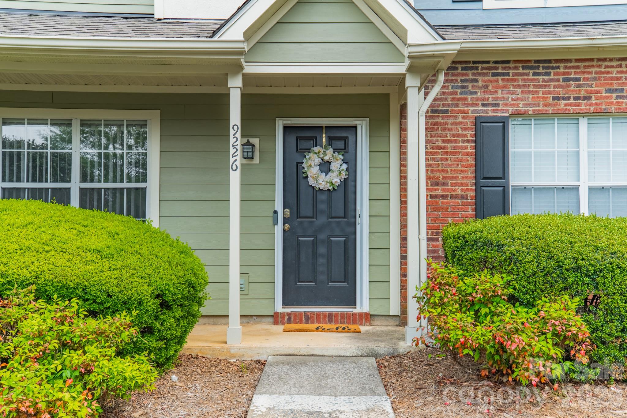 9226 Four Mile Creek Road Charlotte, NC 28277 - Photo 5 of 39 a front view of a house with a garden