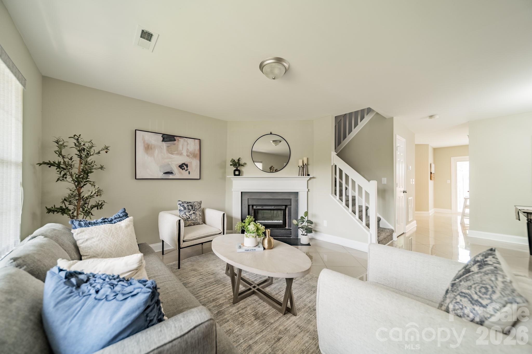 9226 Four Mile Creek Road Charlotte, NC 28277 - Photo 10 of 39 a living room with furniture a fireplace and a potted plant