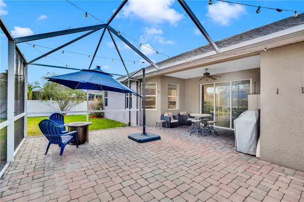 a view of a patio with a table and chairs under an umbrella