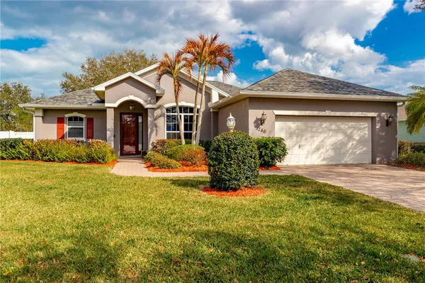 a front view of house with yard and green space