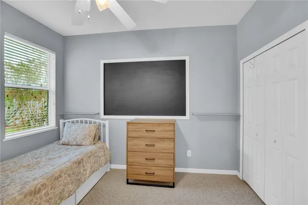 a bedroom with a bed and a television