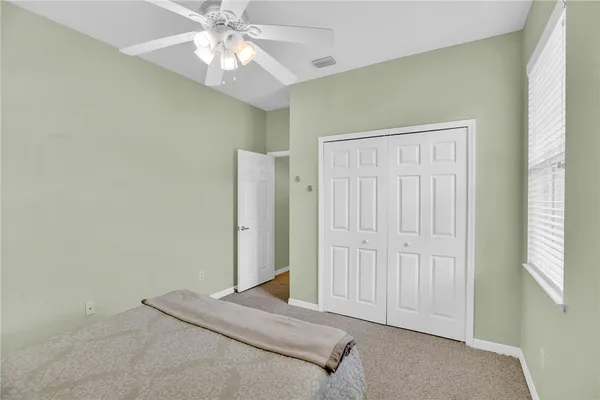 a view of a livingroom with a chandelier fan