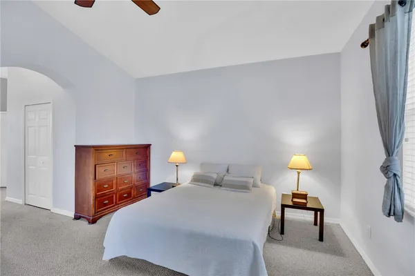 a bedroom with a bed and a lamp on table