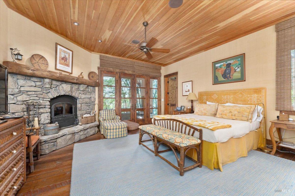 Undisclosed Address Burney, CA 96013 - Photo 14 of 39 a spacious bedroom with a bed and a fireplace