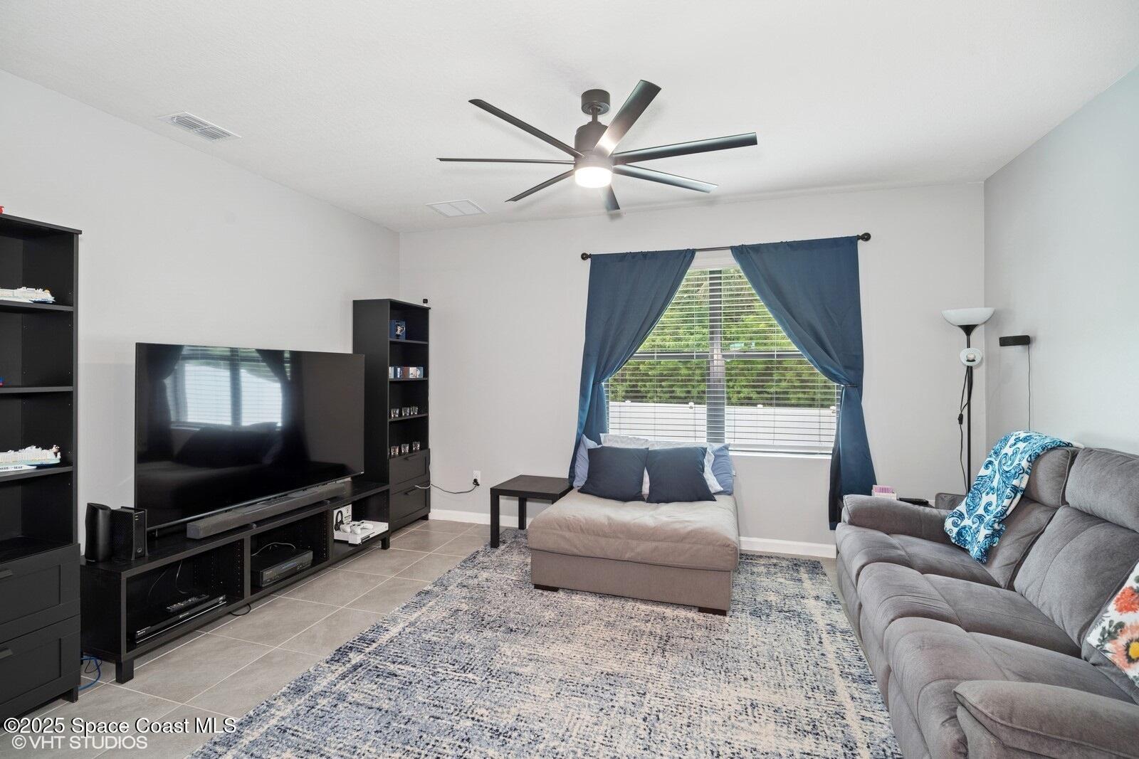 5221 Talbot Boulevard Cocoa, FL 32926 - Photo 12 of 32 a living room with furniture and a flat screen tv