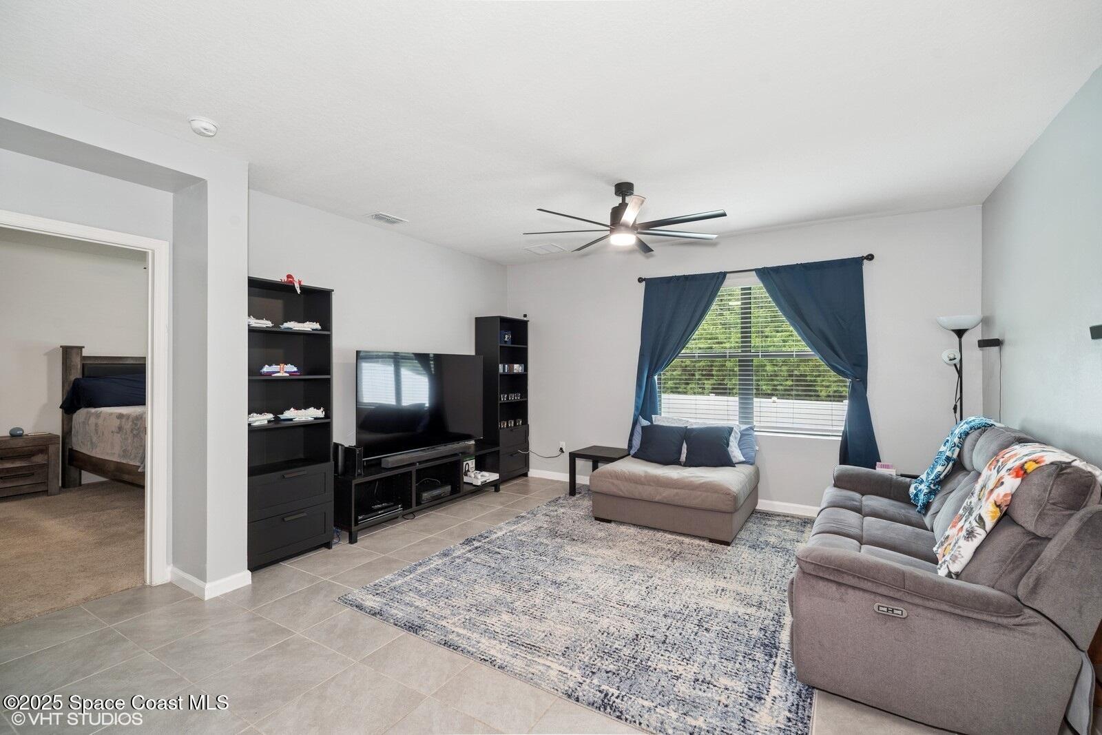 5221 Talbot Boulevard Cocoa, FL 32926 - Photo 13 of 32 a living room with furniture and a flat screen tv