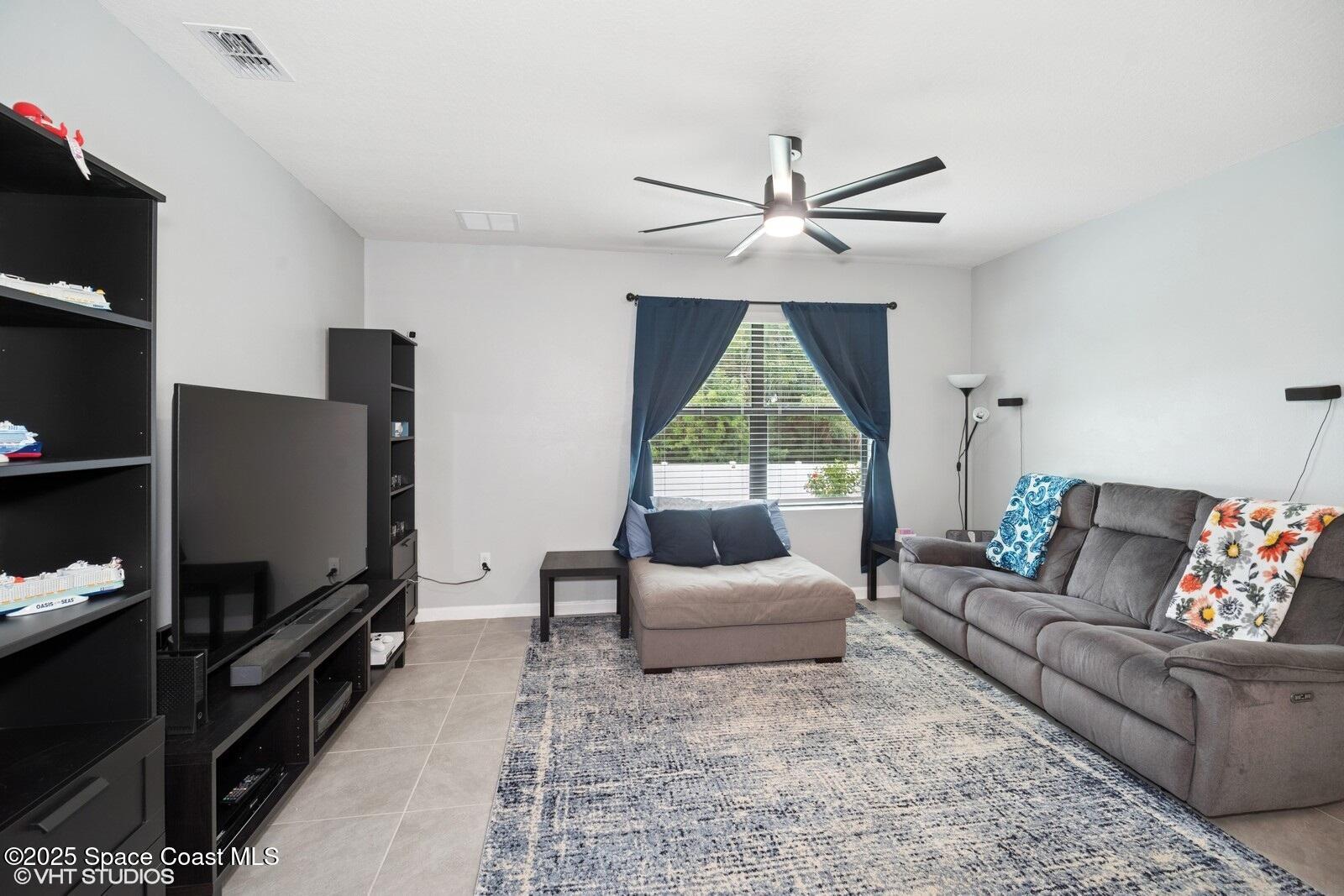 5221 Talbot Boulevard Cocoa, FL 32926 - Photo 14 of 32 a living room with furniture and a flat screen tv