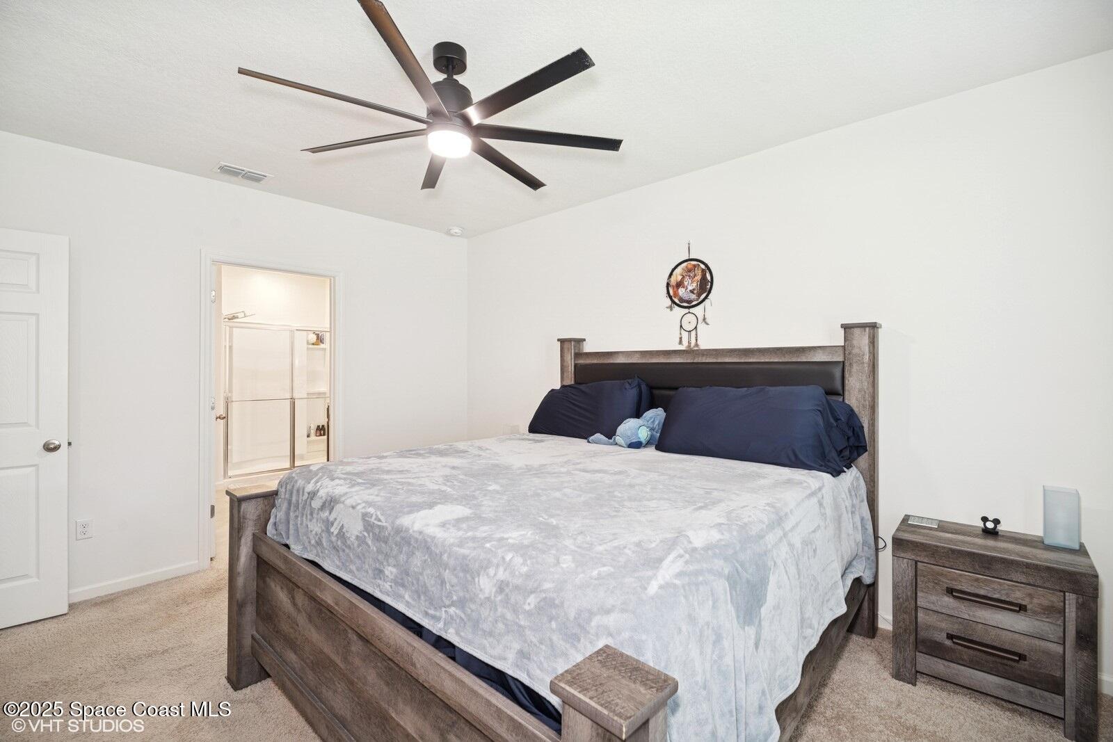 5221 Talbot Boulevard Cocoa, FL 32926 - Photo 16 of 32 a bedroom with a bed and a chandelier